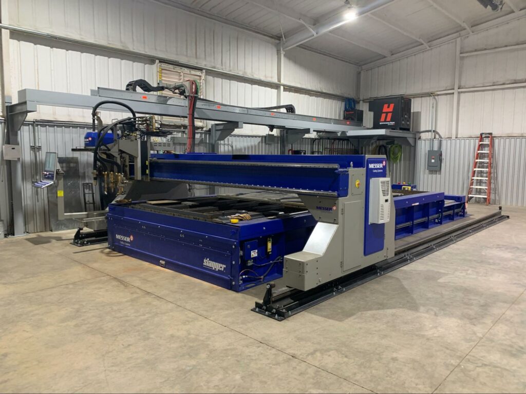  A wide shot of a blue Messer Titan III machine Slagger table.