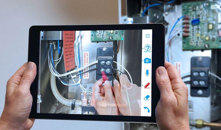 A Messer Cutting Systems technician provides remote repair assistance through remote access virtual service on a tablet.